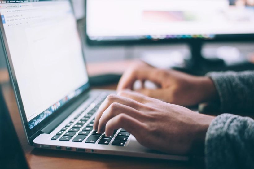 Close up of hands typing on laptop keyboard